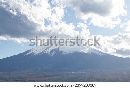 Close up of Mount Fuji or Fujiyama with blue and white sky. It is the highest volcano in Japan. 