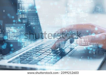 Close up of hands using laptop with creative binary coding hologram on blurry background. Software programming code. Double exposure