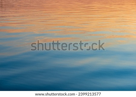 Water surface with ripples for background or texture. Blue and orange abstract desktop background.