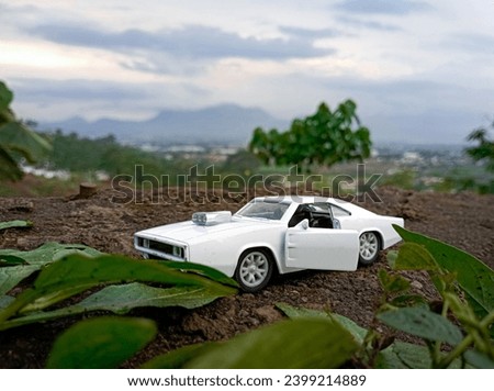 Retro sedan, diecast muscle car being photographed on a mountain, retro car photography
