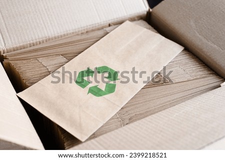 Packaging made from biodegradable materials. Paper bag with a recycling sign. zero waste concept. Royalty-Free Stock Photo #2399218521