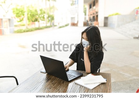 High-quality, free stock photo college students in campus environment, studying, enjoying simple moments, authenticity, a day in the life. Young Asean girl with black laptop
