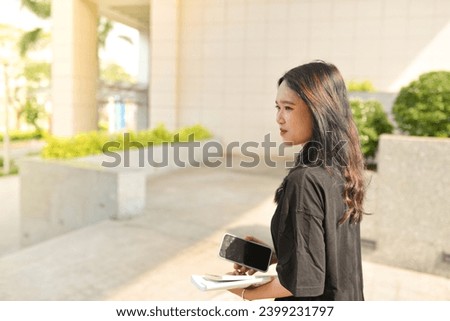 High-quality, free stock photo college students in campus environment, studying, enjoying simple moments, authenticity, a day in the life. Young Asean girl with book, curriculum 
