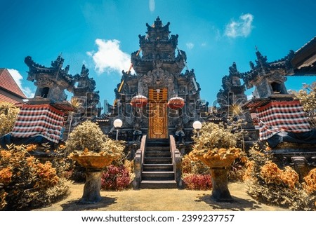 Travel people explore beautiful Bali temple with traditional Hindu symbols decorating the temple on tropical island Bali Indonesia Royalty-Free Stock Photo #2399237757