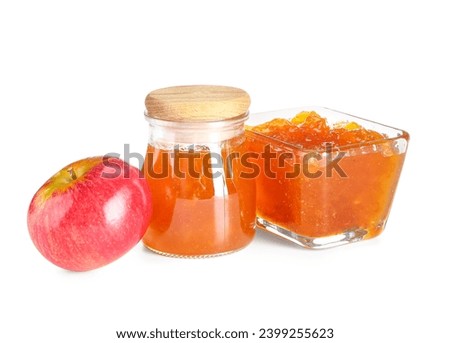 Jar and glass bowl of sweet apple jam on white background