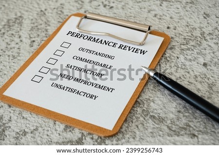 Performance Review checklist on clip board with pen. Performance review concept.