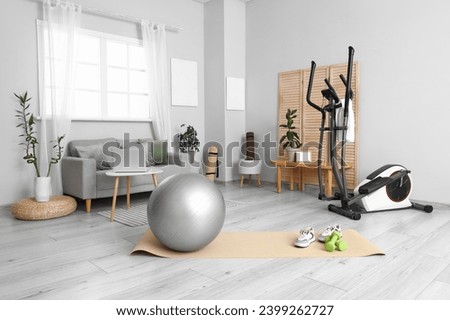 Interior of living room with sports equipment and sofa