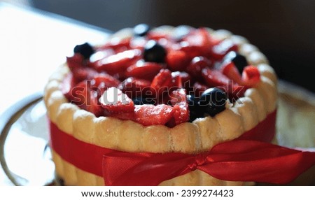 Delicious floury sweet cake with strawberries and currants. Cooking cake at home concept Royalty-Free Stock Photo #2399274423