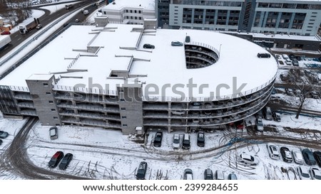 Drone photography of multistory parking lot in a city during winter day