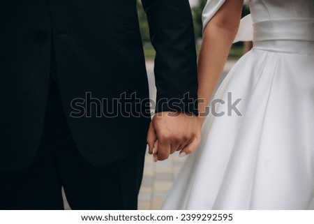 Picture of man and woman with wedding ring.Young married couple holding hands, ceremony wedding day. Newly wed couple's hands with wedding rings. . High quality photo