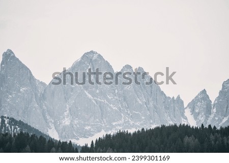 Springtime in the Italian Alps with the sun setting over the Dolomites peaks. Panoramic view of idyllic mountain scenery in the Alps on a beautiful day. Destination traveling.