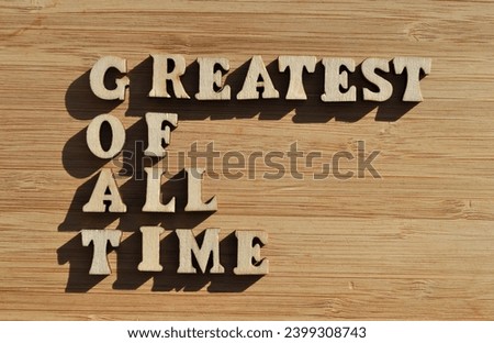 GOAT, acronym for Greatest of All Time, words in wooden alphabet letters isolated on background as banner headline Royalty-Free Stock Photo #2399308743