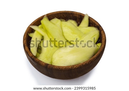 sour mango with sweet brine in a wooden bowl, isolated on white background, concept of process fruit catalog, 45 degree shot
