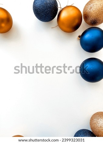 Colorful Christmas balls for the Christmas tree on a white background. Flat lay of blue and bronze Christmas balls, top view. Place for text