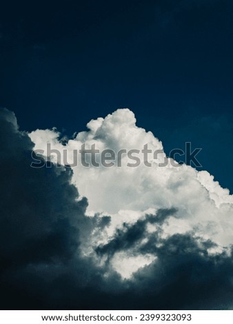 white clouds above black clouds