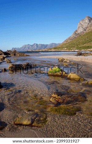 View of the gorgeous Rooi Els beach and estuary with the Kogelberg Mountains and Clarence Drive in the background. Western Cape. South Africa