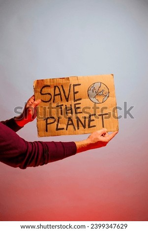 Cardboard sign that says SAVE THE PLANET