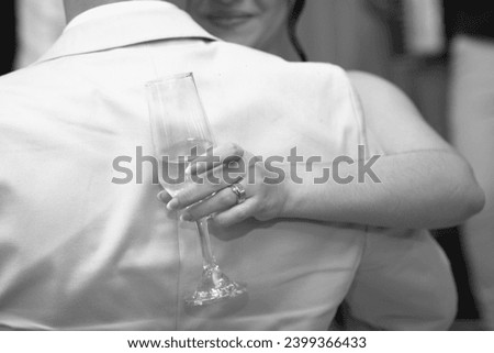 bride and groom, bride and groom holding glasses, bride and groom dancing, black and white image, close up bride and groom