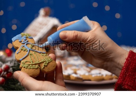Decorating Christmas gingerbread with sugar multicolored icing