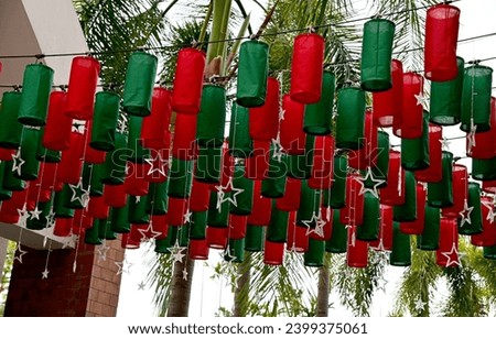 Christmas background with Green and Red Paper Lanterns hang above in beautiful rows background for design and decoration at Thailand. Selective Focus.