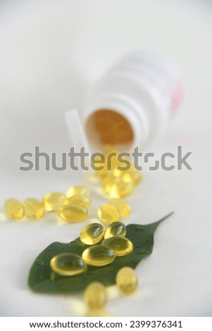 Transparent yellow capsules, drugs, vitamins on white background. Vitamin translucent pill drug, capsule translucent pharmaceutical. 
omega 3, transparent yellow capsules of fish oil.