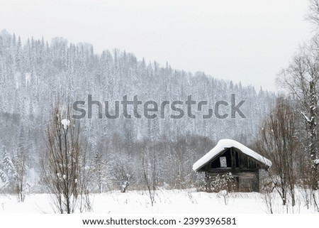 cozy, snow-covered small wooden house. concept of winter peace and recreation in the mountains.