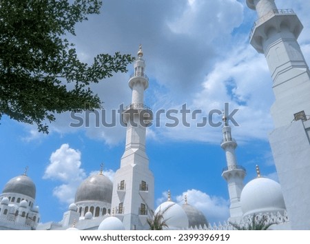 You can see the mosque dome and mosque tower high in the bright blue sky and white clouds of the Syech Zayed mosque building in Solo, Central Java, Indonesia  Royalty-Free Stock Photo #2399396919