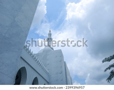 You can see the mosque dome and mosque tower high in the bright blue sky and white clouds of the Syech Zayed mosque building in Solo, Central Java, Indonesia  Royalty-Free Stock Photo #2399396957