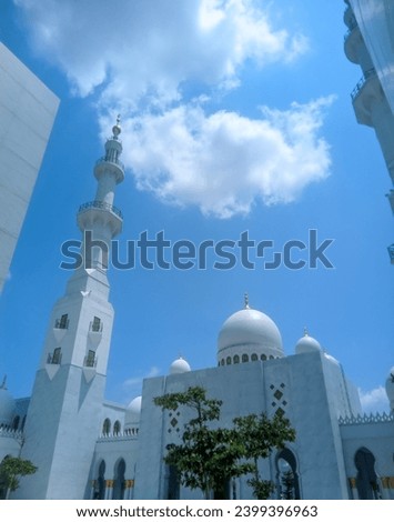 You can see the mosque dome and mosque tower high in the bright blue sky and white clouds of the Syech Zayed mosque building in Solo, Central Java, Indonesia  Royalty-Free Stock Photo #2399396963