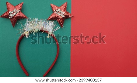 decorated Beautiful headband funny red star isolate on a green and red backdrop.
concept of joyful Christmas party,New year is coming soon, festive season decoration with Christmas elements