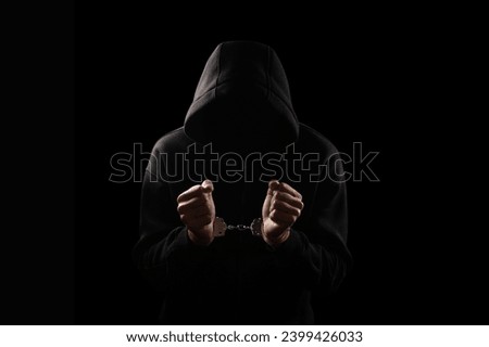 Silhouette of handcuffed male in hoodie, dangerous criminal punished by law Royalty-Free Stock Photo #2399426033