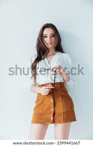 fashionable woman in blouse and yellow skirt on white background