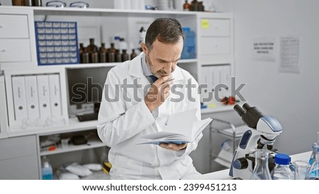 Middle-aged man with grey hair, dedicated scientist! working hard on his report from the lab, pushing the boundaries of medicine. Royalty-Free Stock Photo #2399451213