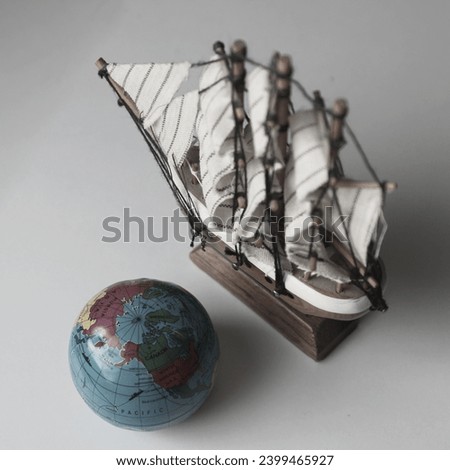 Miniature Globe Near Sailing Vessel Model On White Old Film Style Stock Photo