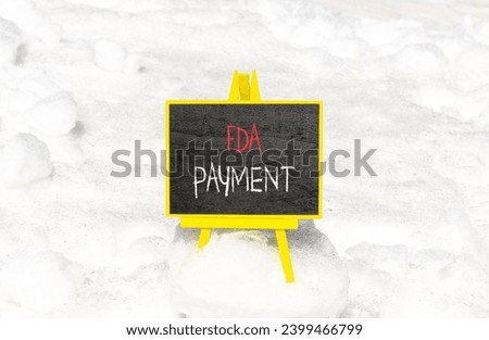 FDA Food and Drug Administration payment symbol. Concept words FDA payment on beautiful black chalk blackboard. Beautiful white snow background. Business FDA payment concept. Copy space.