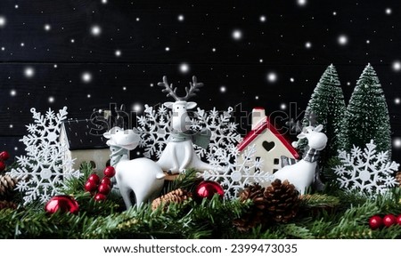 Holiday card, Merry Christmas and Happy New Year.  White deer on a Christmas background, branches of spruce houses and gentle snowfall.  Foreground.  Christmas and New Year holiday concept.