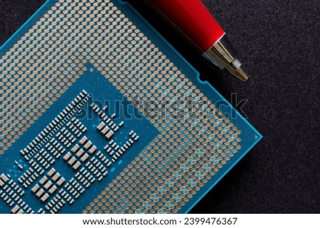 Modern powerful multi-core personal computer processor compared to the tip of a pen. New generation of CPU. Built-in video core. Photo. Macro. Selective focus. Close-up Royalty-Free Stock Photo #2399476367