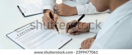 Business executive signing contract agreement document on the bale with the help from company attorney or lawyer service in law firm office. Business investing and finalizing legal processing. Shrewd Royalty-Free Stock Photo #2399477061