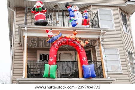Festive Christmas decorations adorn the exterior of a cozy home, creating a warm and inviting holiday atmosphere