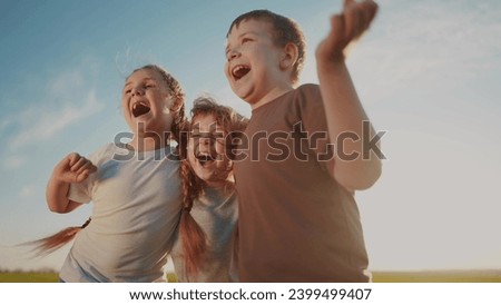group of kids team hugging a jumping and rejoicing outdoors. happy family teamwork kid dream concept. family children sisters brothers have lifestyle fun hugging in the park in nature Royalty-Free Stock Photo #2399499407