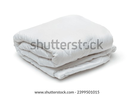 Folded white soft quilt blanket isolated on white Royalty-Free Stock Photo #2399501015
