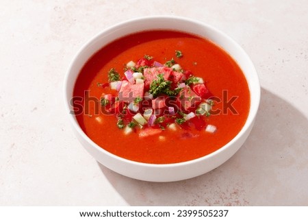 Spanish tomato and watermelon gazpacho cold soup styled and decorated in white plate Royalty-Free Stock Photo #2399505237