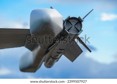 Part of a military fighter aircraft. Cruise missile on the wing of a fighter jet. High technology military industrial complex. Royalty-Free Stock Photo #2399507927