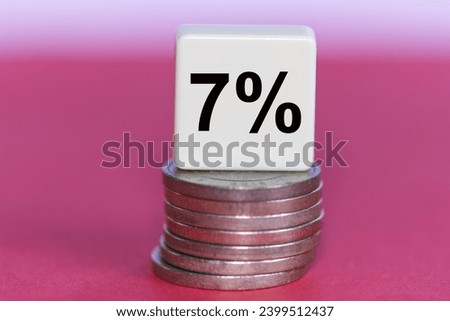 The concept of the word 7 percent on seven coins. Business concept.