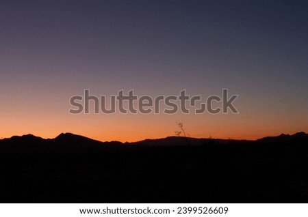 Panorama shot of colorful sunset with black mountains horizon in american nature, Mount Whitney, usa Royalty-Free Stock Photo #2399526609