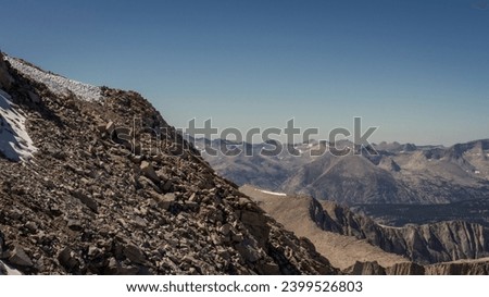 Steep rocky mountain wall to top of White Mountney with view on tops of Sierra Nevada in America, usa at sunny day Royalty-Free Stock Photo #2399526803