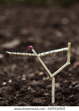 Matchstick figure A figure made of matches in the form of a dance on a background of ground Royalty-Free Stock Photo #2399534503
