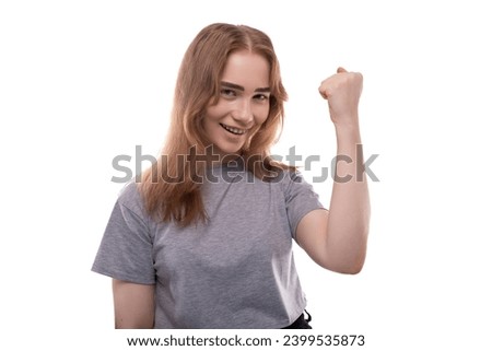 Headshot portrait of lucky teenage girl in gray t-shirt