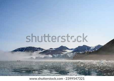 Adventure seeking people kayaking in the freezing waters of the arctic ocean at the base of the Monacobreen Glacier in Liefde Fjord, Svalbard, travel in the arctic summer
 Royalty-Free Stock Photo #2399547321