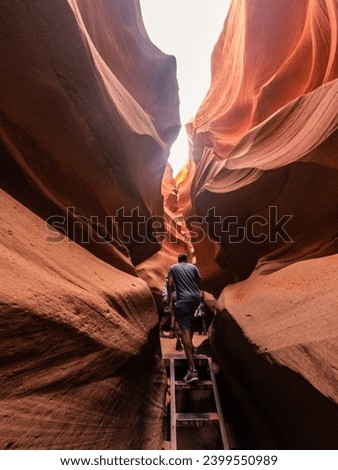 People in water shaped smooth sandstone walls to unusual curves and adges in antelope national park in arizona, america, usa Royalty-Free Stock Photo #2399550989